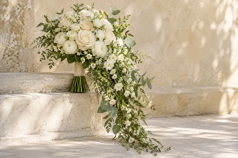 Original cascading bouquet concept with an ivory flower cluster and a long tapered trail of green foliage.